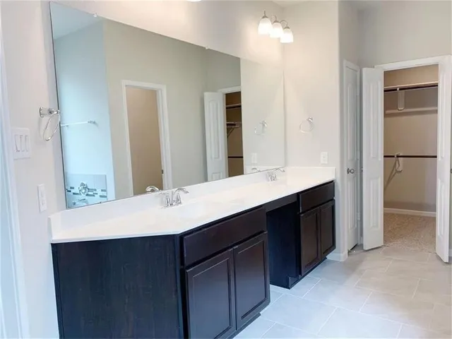 a bathroom with a sink a shower and a mirror