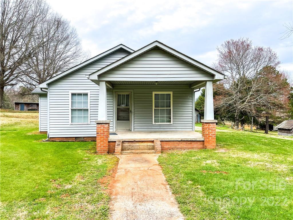 8548 Jc Road Vale, NC 28168 - Photo 2 of 20 a front view of a house with a yard and garage
