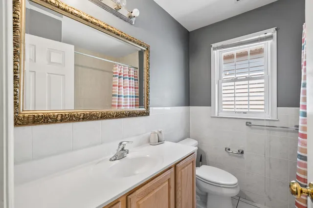 a bathroom with a sink a toilet and a mirror