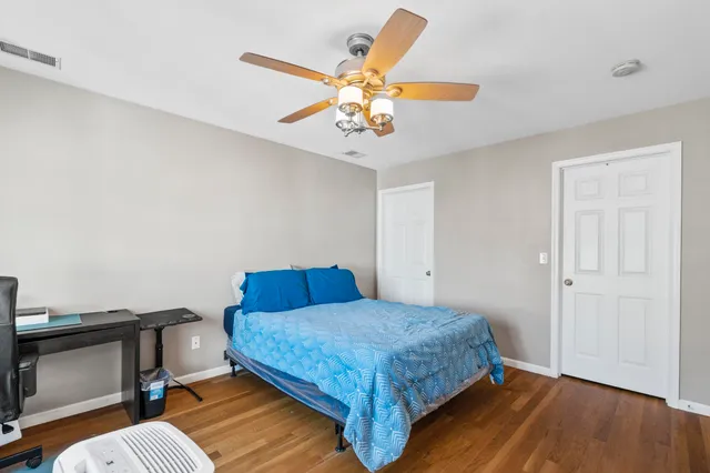 a bedroom with a bed and a chandelier