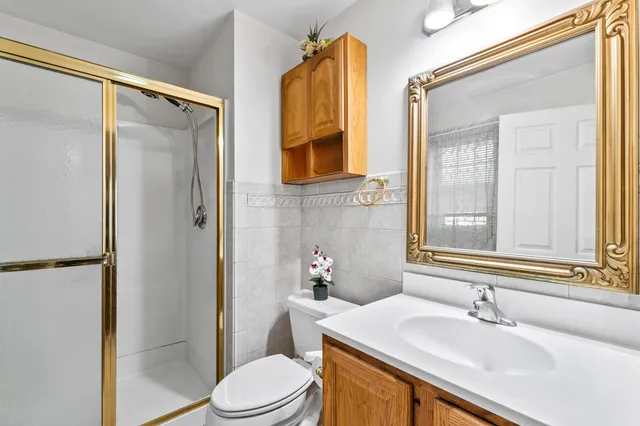 a bathroom with a sink a toilet and shower