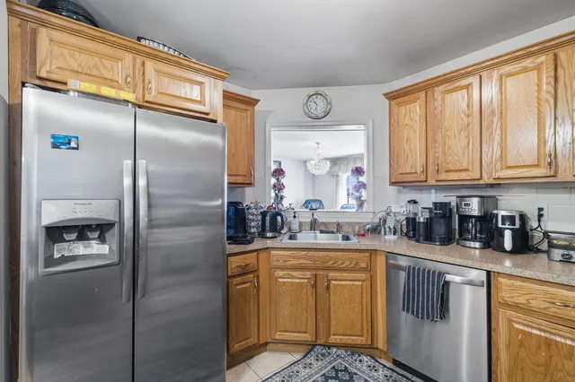 a kitchen with stainless steel appliances granite countertop a refrigerator and a stove