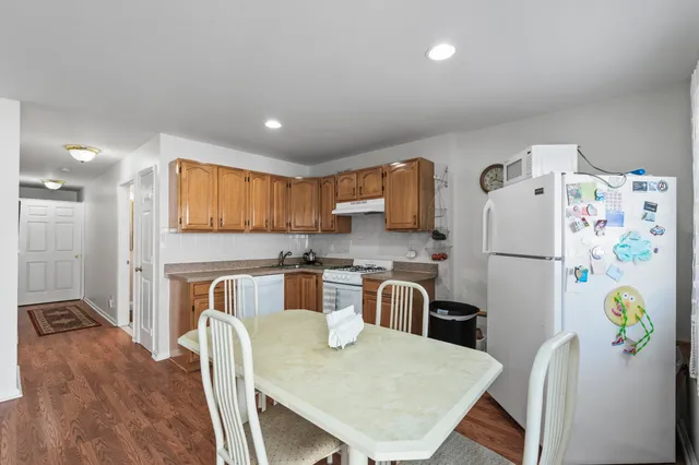 a kitchen with stainless steel appliances granite countertop a refrigerator and a stove top oven