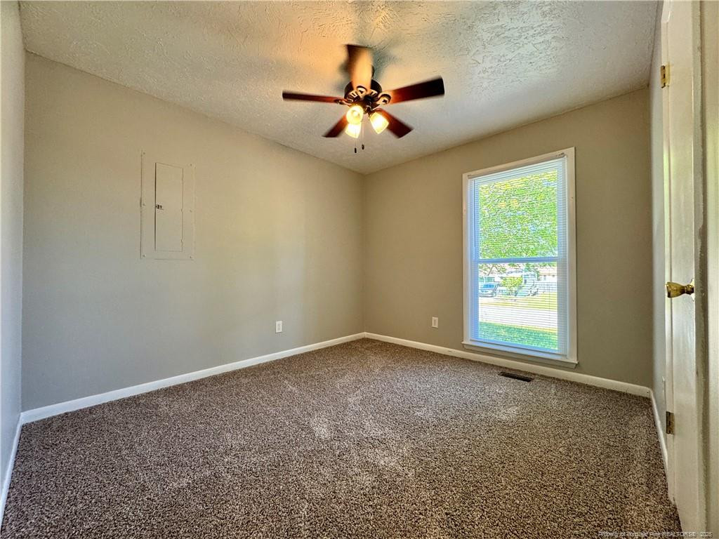 3323 Balero Court Spring Lake, NC 28390 - Photo 11 of 16 an empty room with a window and a ceiling fan