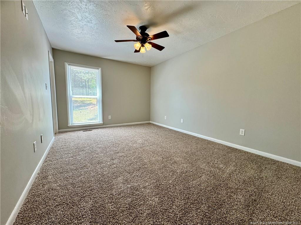 3323 Balero Court Spring Lake, NC 28390 - Photo 13 of 16 a view of a livingroom with a ceiling fan and window