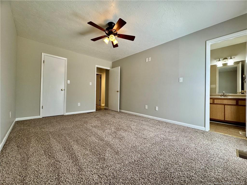 3323 Balero Court Spring Lake, NC 28390 - Photo 14 of 16 a view of a livingroom with a ceiling fan window and kitchen view