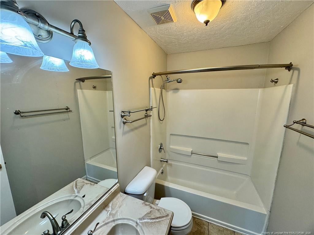3323 Balero Court Spring Lake, NC 28390 - Photo 3 of 16 a bathroom with a sink a toilet and shower