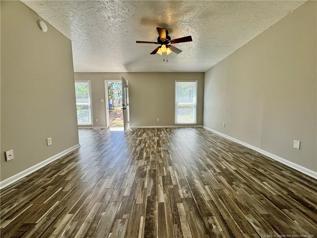 3323 Balero Court Spring Lake, NC 28390 - Photo 4 of 16 wooden floor in an empty room with a window