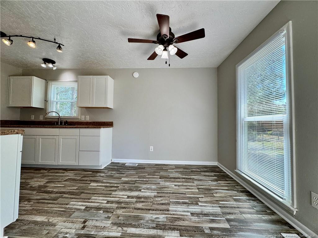 3323 Balero Court Spring Lake, NC 28390 - Photo 6 of 16 a living room with kitchen island granite countertop furniture and a fireplace