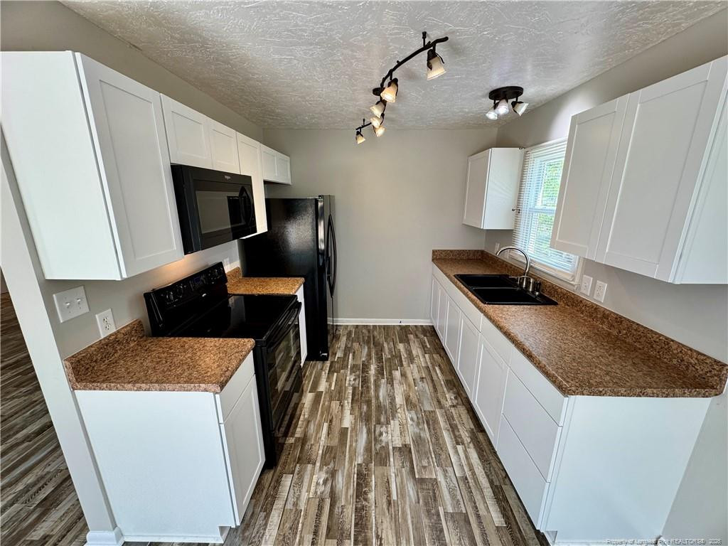 3323 Balero Court Spring Lake, NC 28390 - Photo 7 of 16 a kitchen with sink stove and refrigerator