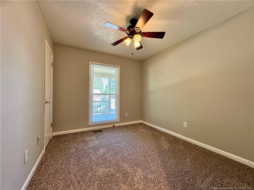 3323 Balero Court Spring Lake, NC 28390 - Photo 9 of 16 an empty room with windows and fan