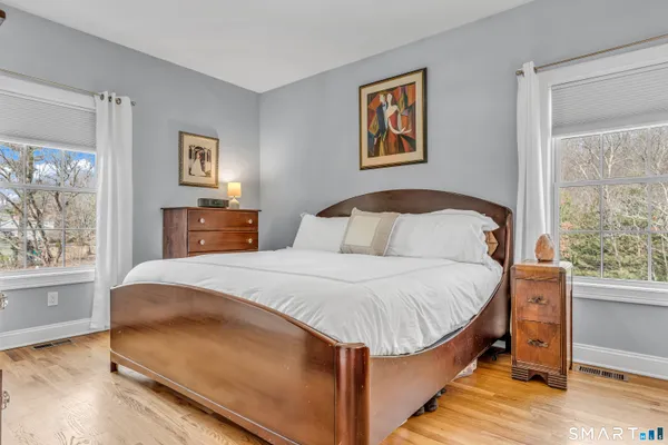 a bedroom with a large bed and a window