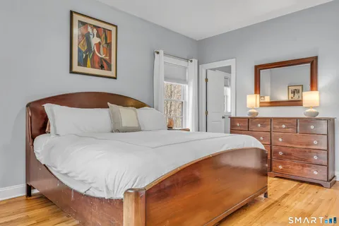 a bedroom with a bed and a dresser