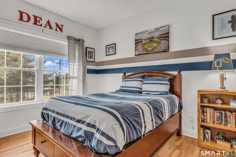 a bedroom with a bed and a book shelf