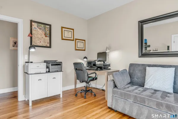 a work room with furniture and wooden floor