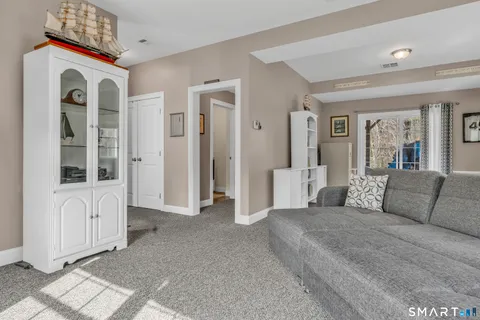 a spacious bedroom with a large bed and a chandelier