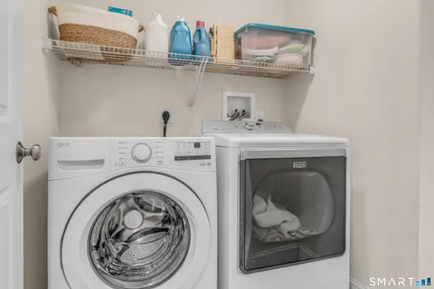 a bathroom with a granite countertop toilet sink and mirror