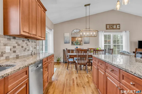 a dining room with granite countertop furniture and wooden floor