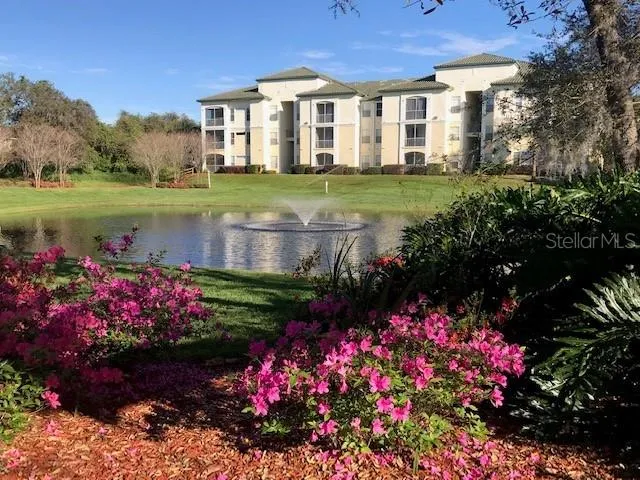 a view of a house with a yard and garden