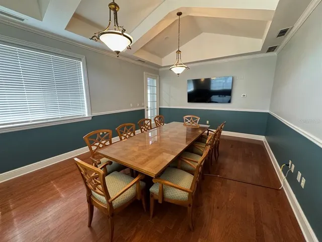 a outdoor dining space with furniture and wooden floor