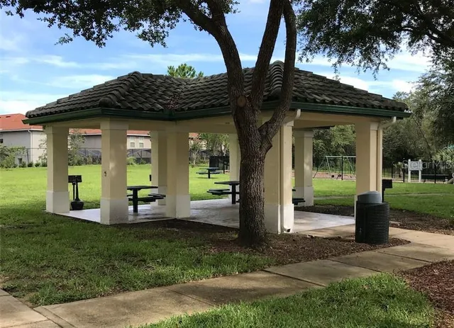a view of a wooden deck with chairs and a yard