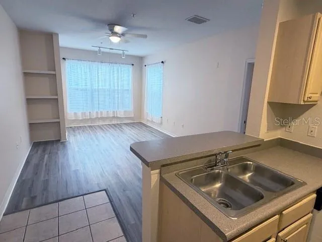a kitchen with a sink and a stove top oven