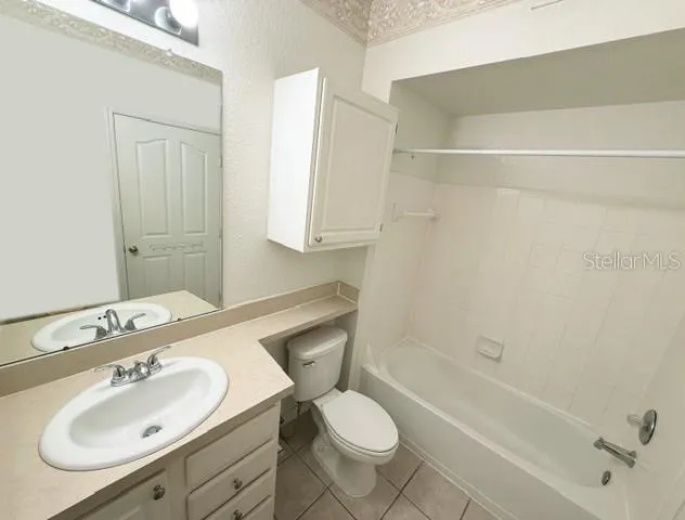 a bathroom with a sink toilet tub and shower