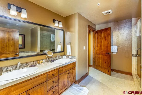 a spacious bathroom with a granite countertop sink mirror and double