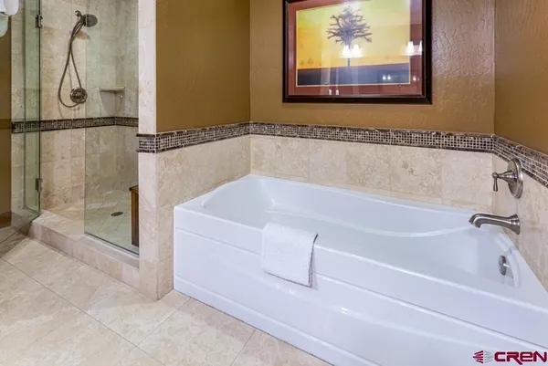 a white bath tub sitting next to a shower