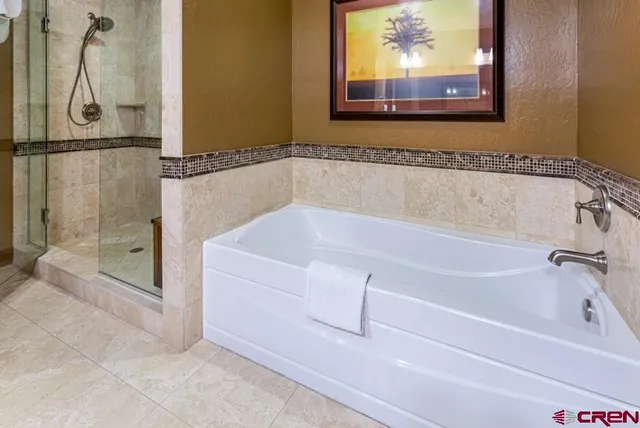 a white bath tub sitting next to a shower