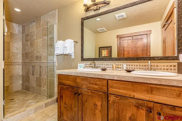 a bathroom with a sink vanity and a mirror