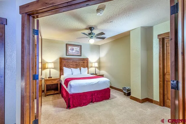 a bedroom with a bed and a chandelier