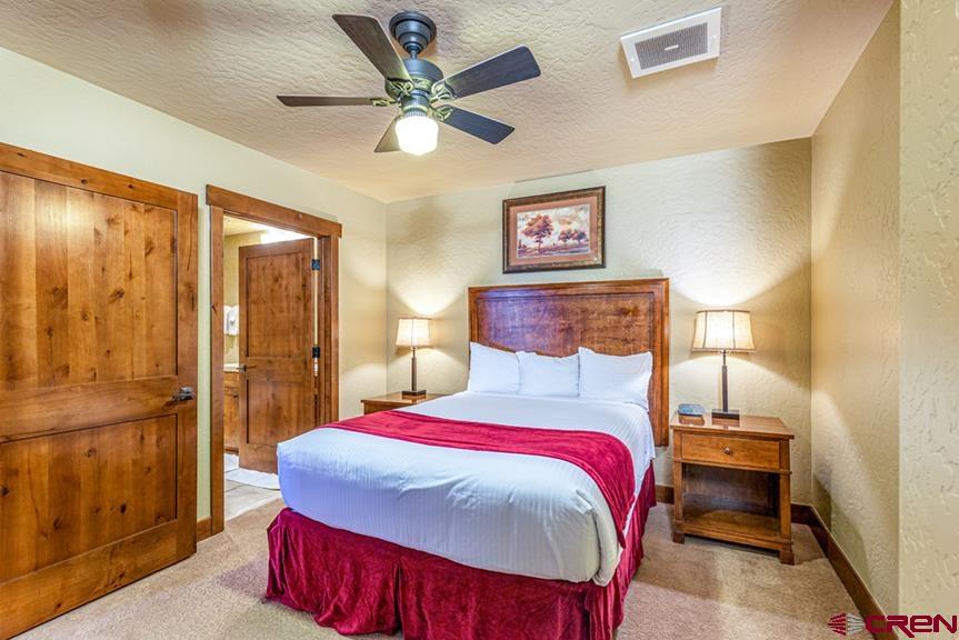 24 Sheol Street, Unit 503 R23 Durango, CO 81301 - Photo 22 of 44 a bedroom with a bed and a chandelier