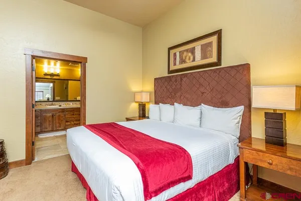 a bedroom with a bed and a view of kitchen