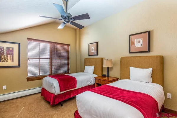 a bedroom with two beds and a window