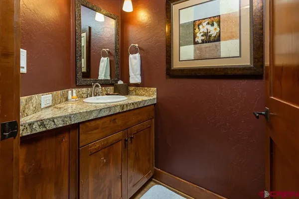 a bathroom with a sink mirror and vanity