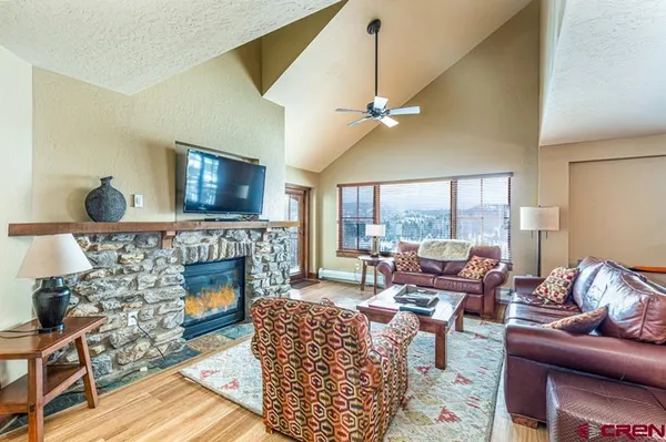 a living room with furniture and a fireplace