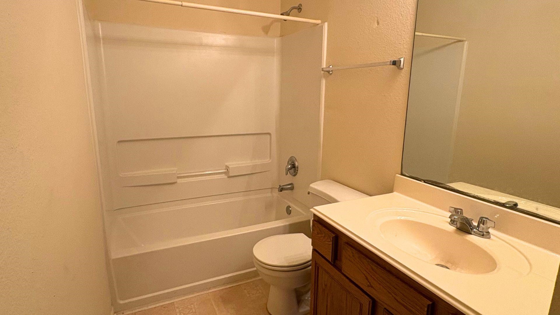 21842 Grassy Hill Lane Spring, TX 77388 - Photo 7 of 9 a bathroom with a sink a toilet and shower