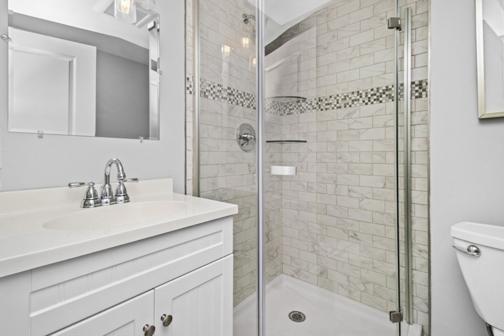 16 Port Norfolk Street, Unit 2 Boston, MA 02122 - Photo 11 of 20 a bathroom with a sink a toilet and shower
