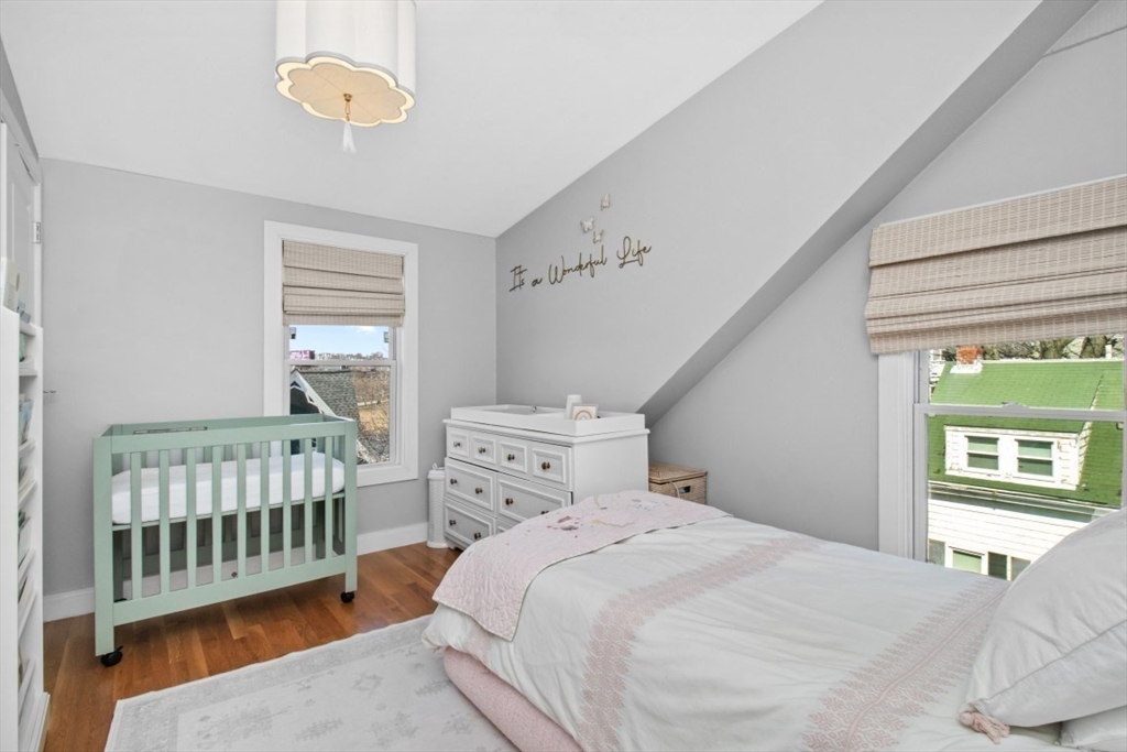 16 Port Norfolk Street, Unit 2 Boston, MA 02122 - Photo 13 of 20 a bedroom with a bed and a window