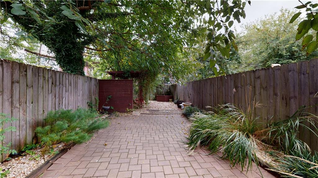 722 Madison Street Brooklyn, NY 11221 - Photo 13 of 29 a view of a backyard with plants and wooden fence