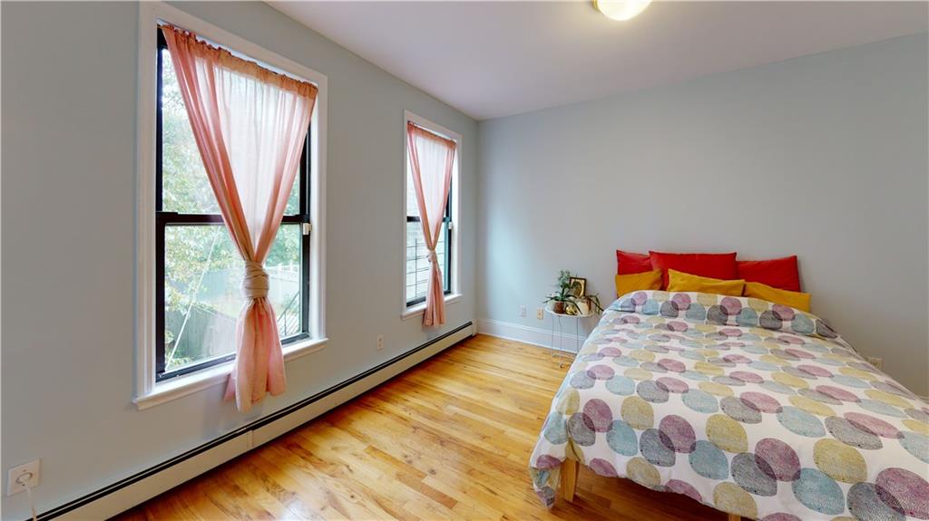 722 Madison Street Brooklyn, NY 11221 - Photo 14 of 29 a bedroom with a bed and a window