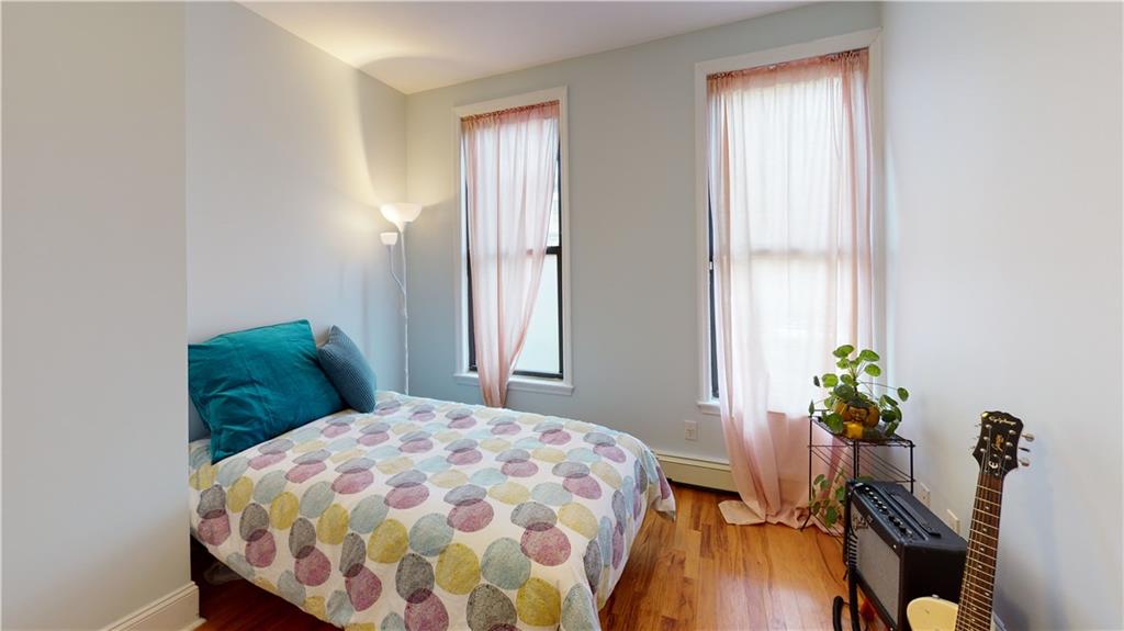 722 Madison Street Brooklyn, NY 11221 - Photo 15 of 29 a bedroom with a bed and a window