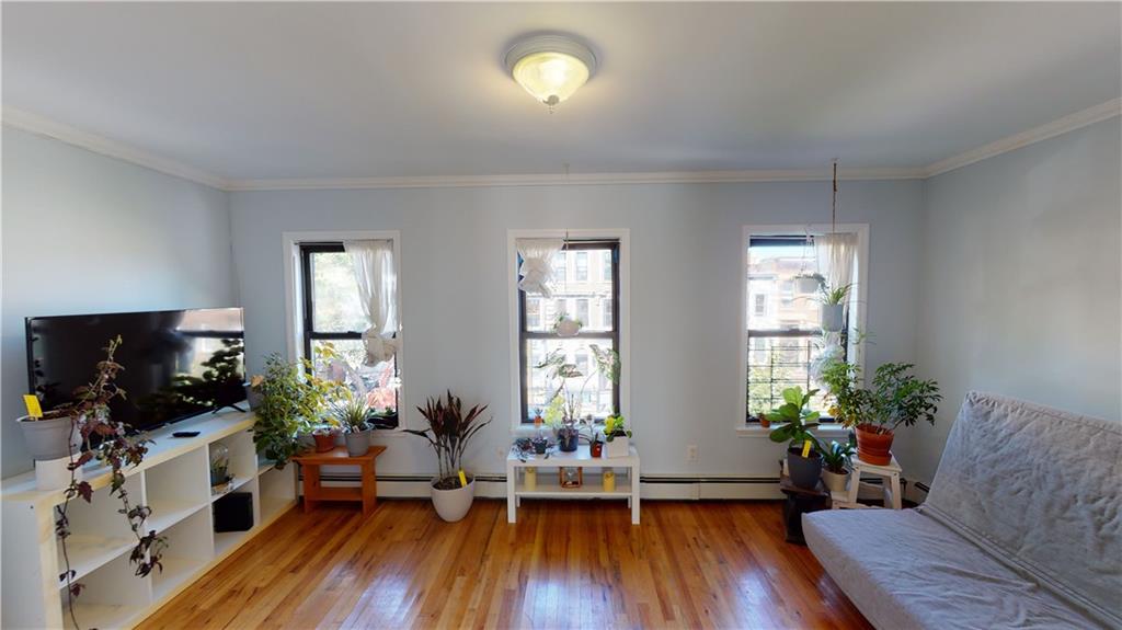 722 Madison Street Brooklyn, NY 11221 - Photo 18 of 29 a living room with furniture fireplace and flat screen tv