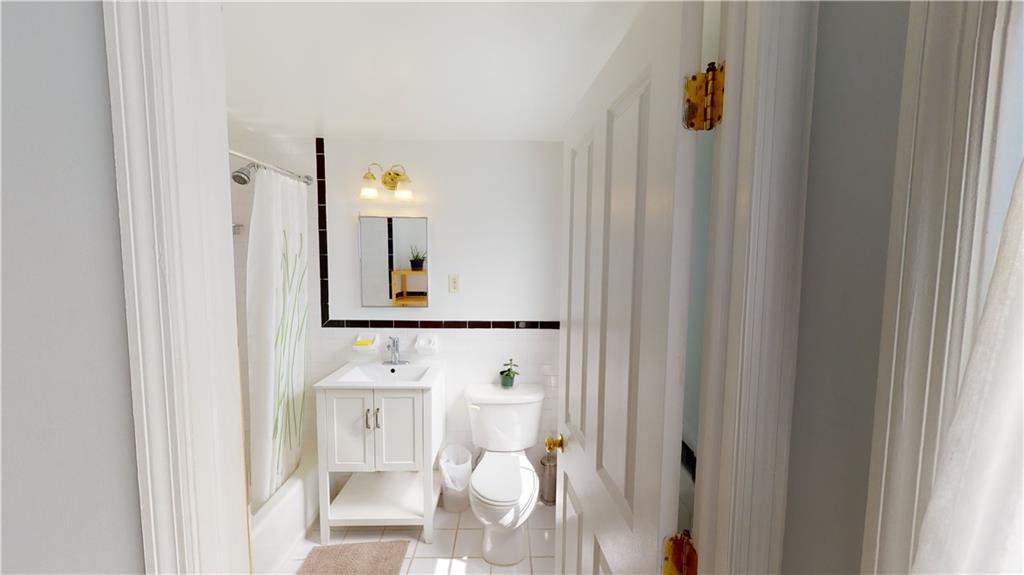 722 Madison Street Brooklyn, NY 11221 - Photo 23 of 29 a bathroom with a toilet sink and mirror