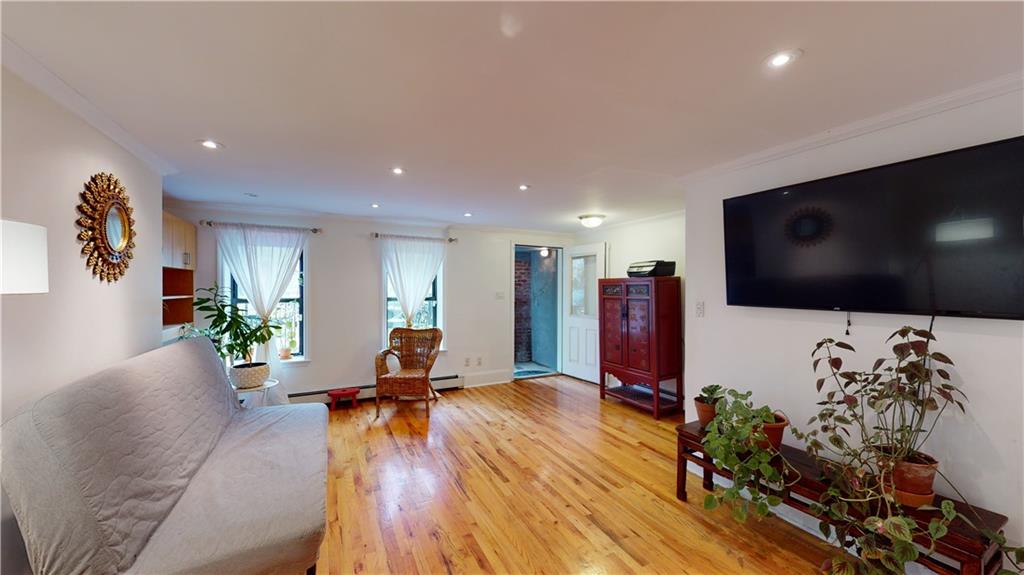 722 Madison Street Brooklyn, NY 11221 - Photo 5 of 29 a living room with furniture and a flat screen tv
