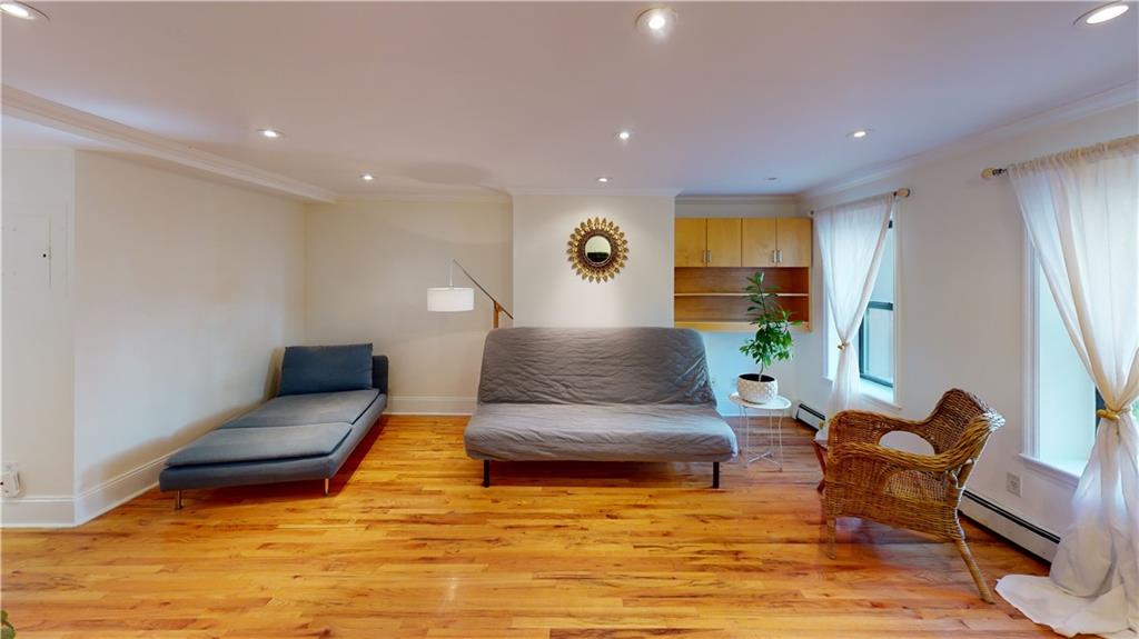 722 Madison Street Brooklyn, NY 11221 - Photo 6 of 29 a living room with furniture and a large window