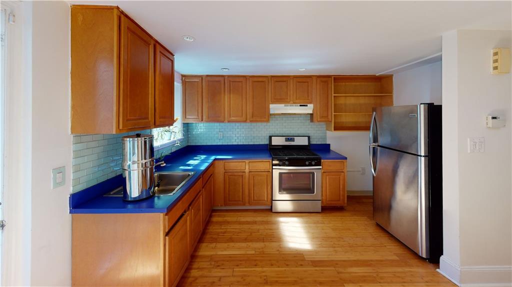 722 Madison Street Brooklyn, NY 11221 - Photo 8 of 29 a kitchen with stainless steel appliances granite countertop a refrigerator a stove and a sink