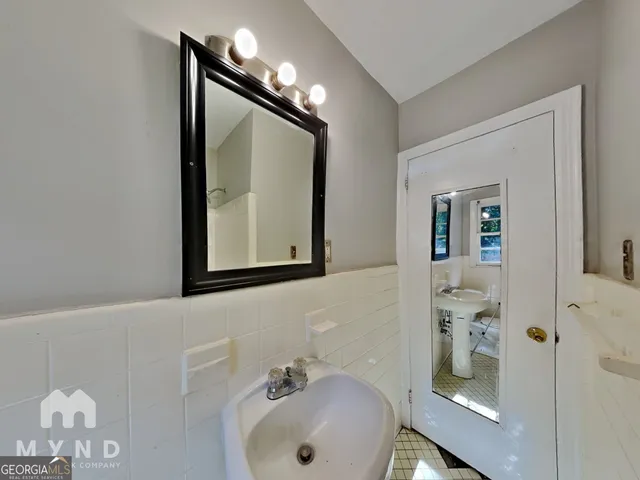 a bathroom with a sink mirror and vanity