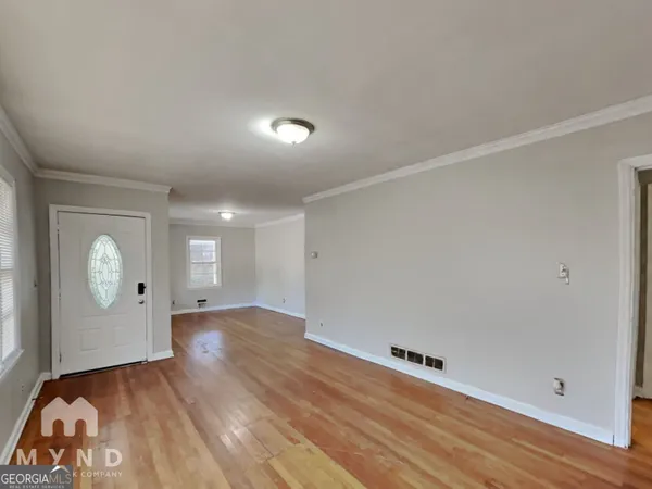 a view of an empty room and wooden floor